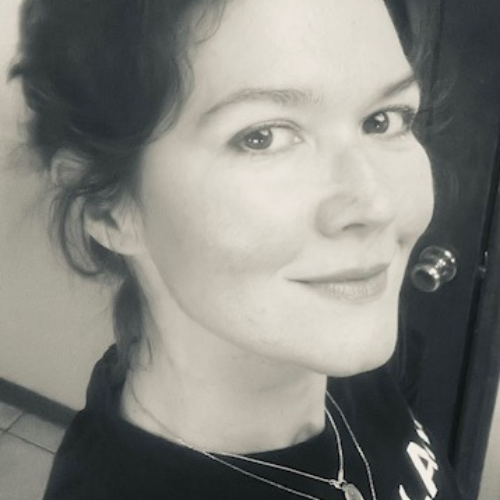 Amber is a teacher here at Om Reset. She is in a seated pose.